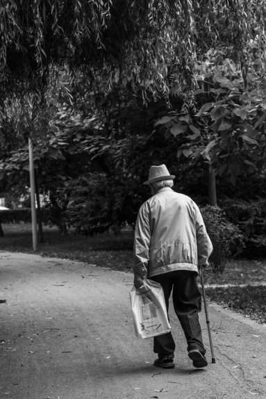 grayscale-back-view-photo-of-elderly-man-with-cane-walking-2586537